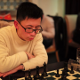 Frank Eyes the Board.  Always intense over the board, Frank Zheng wrangles with multiple variations.