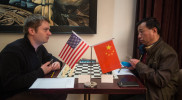 Li Junqi and Justin Clairmont square off over the board.